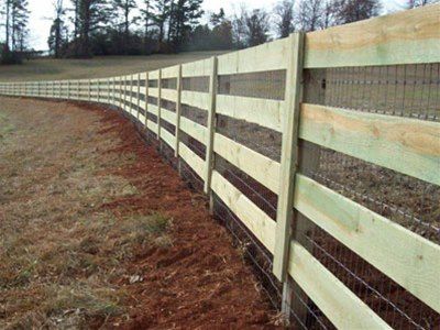 corral fence enclosing a pasture with welded wire added