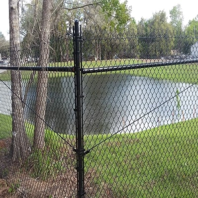 seven foot black chain link fence commercial surrounding pond