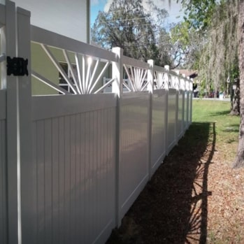 white vinyl fence on side yard of a home