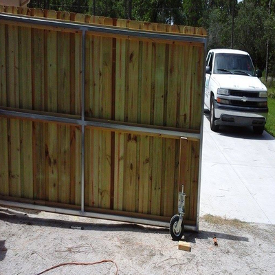 Wood gate on wheels for opening and closing of motor home access to house