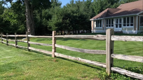 split rail cedar fence separating yards
