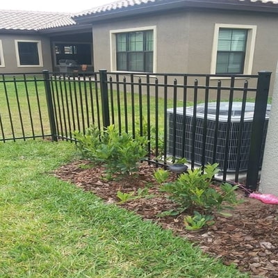 three foot iron fence surrounding a yard 